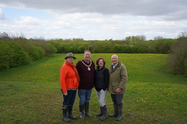 A group of people stood in front of a wood