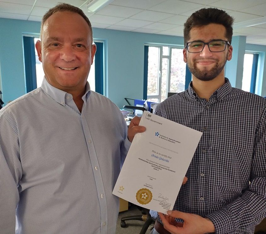 Two men side by side holding a certificate