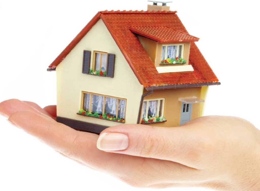 House resting on palm of a lady's hand