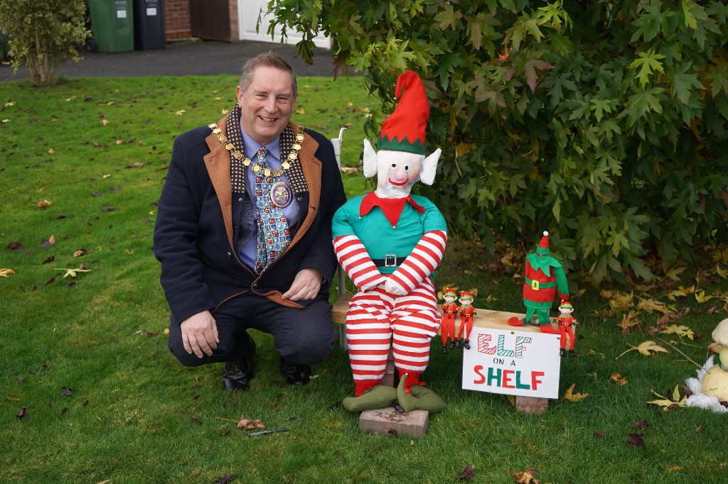 Cllr Raphael sat next to an Elf on the shelf