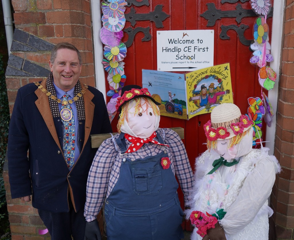 Cllr Raphael stood next to two scarecrows getting married.