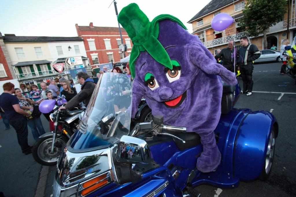 Prunella the Pershore Purple Plum sat on one of the many bikes at Pershore’s Bike Nite Prunella the Pershore Purple Plum sat on one of the many bikes at Pershore’s Bike Nite