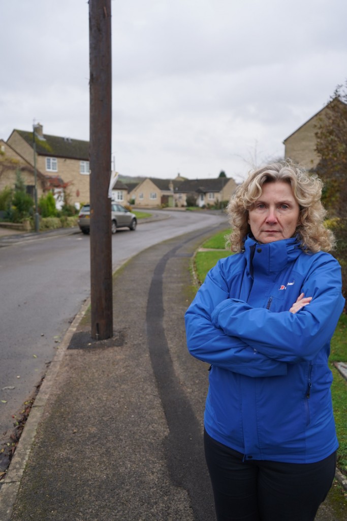 Cllr Emma Kearsey stood in front of a communications pole with her arms folded