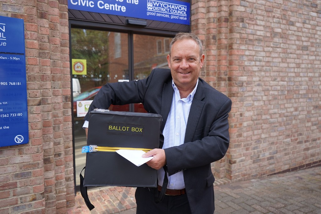 A man holding a ballot box.