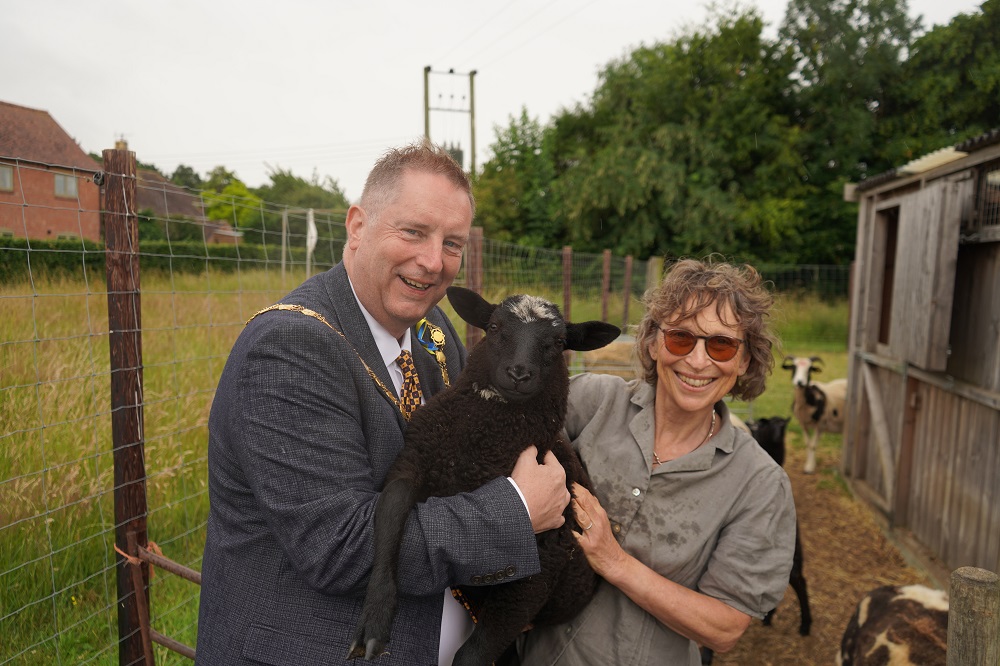 Cllr Raphael and Isobel Meikle from Wick Care Farm holding a sheet between them