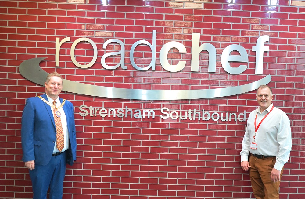 Two men stood in front of a wall