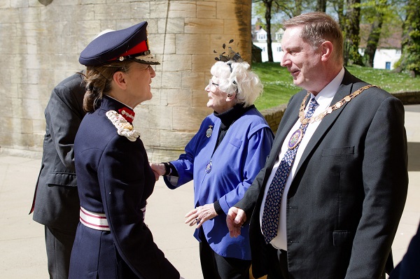 A woman shaking hands with a man