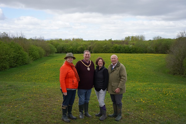A group of people stood in front of a wood