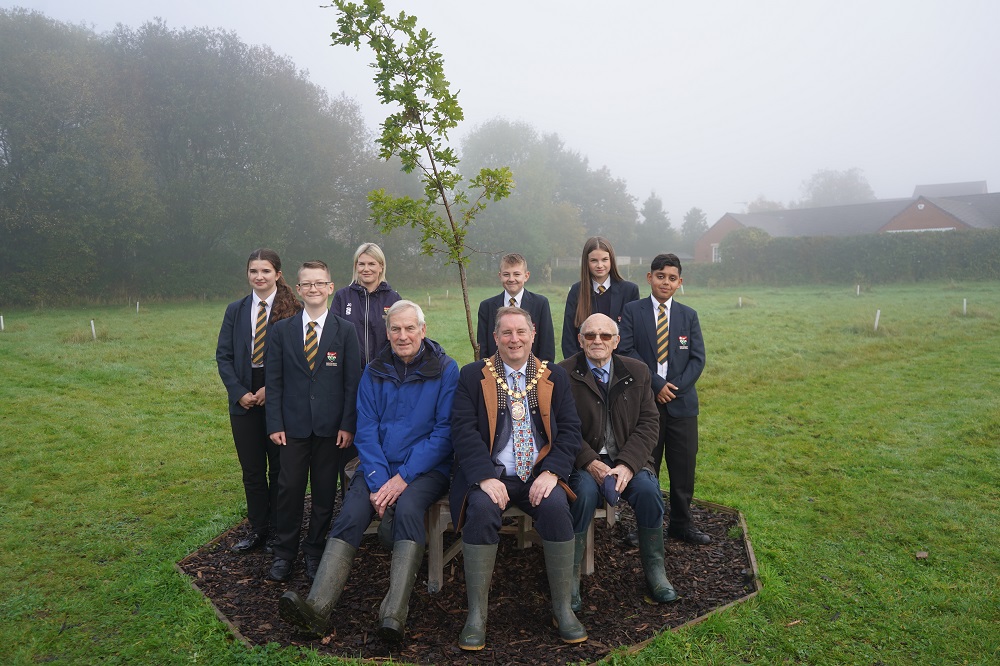 A group of people sat around a tree